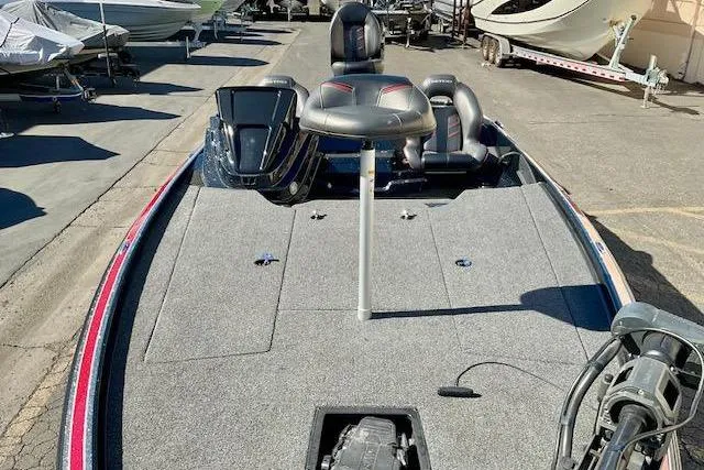 Slide: The Image of 2024 Nitro Z20 Pro fishing boat with spacious deck and seating, parked outdoors. - 8