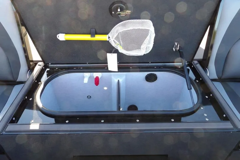 Slide: The Image of Open livewell in 2026 Lund 1975 Renegade boat, featuring a net and aeration system. - 13