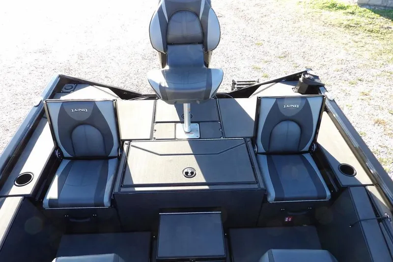 Slide: The Image of 2026 Lund 1975 Renegade boat interior with three gray seats and storage compartments. - 16