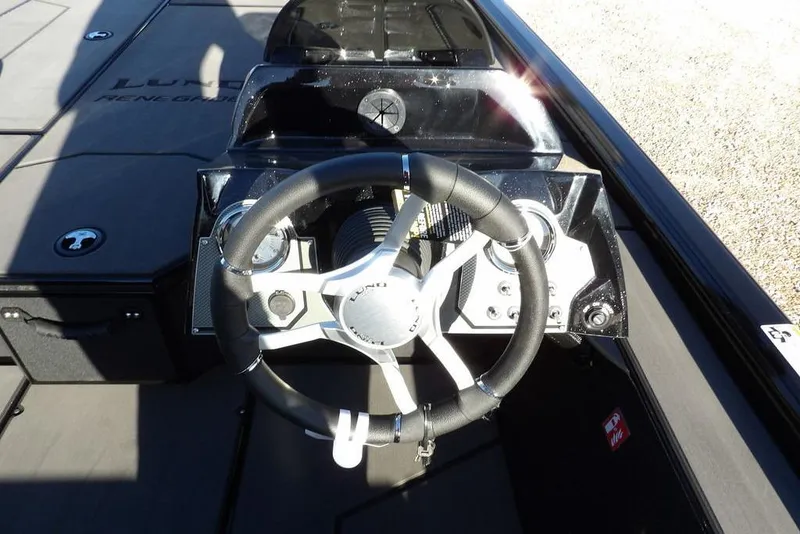 Slide: The Image of Steering console of 2026 Lund 1975 Renegade boat, featuring modern controls and sleek design. - 18