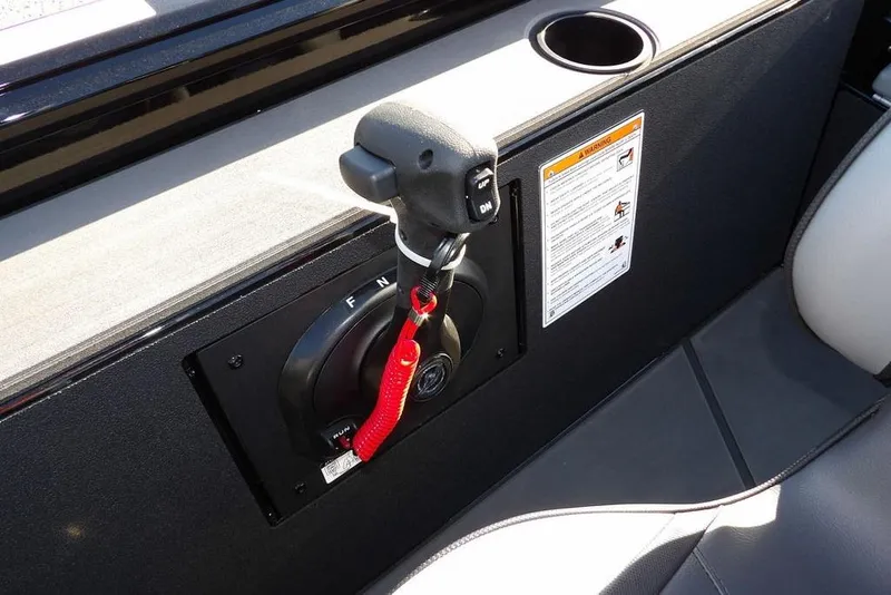 Slide: The Image of Control panel of 2026 Lund 1975 Renegade boat with throttle and warning label. - 25