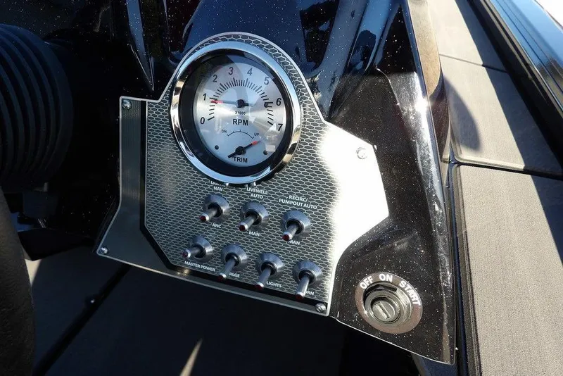 Slide: The Image of Dashboard of 2026 Lund 1975 Renegade boat with RPM gauge and control switches. - 26