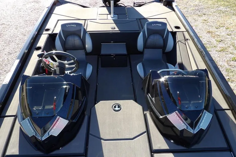 Slide: The Image of 2026 Lund 1975 Renegade boat interior with dual seats and steering wheel. - 31