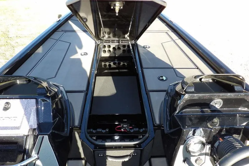 Slide: The Image of 2026 Lund 1975 Renegade boat interior with open storage compartment and dual engines. - 36