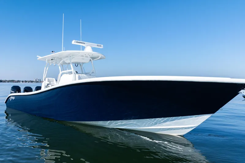 The Image of 2014 Yellowfin 36 Offshore boat on calm water under clear blue sky. - 0