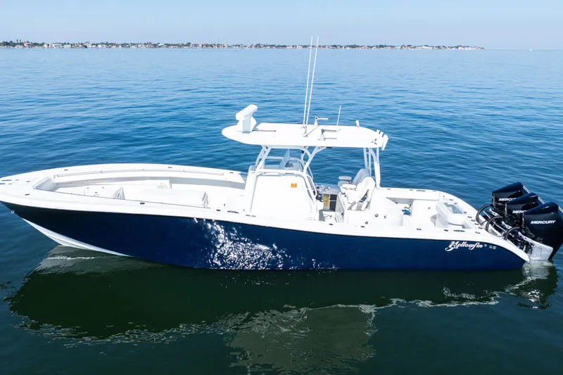 Slide: The Image of 2014 Yellowfin 36 Offshore boat on calm blue water, featuring triple Mercury engines. - 10