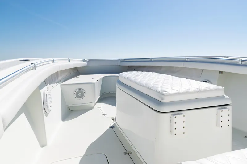 Slide: The Image of 2014 Yellowfin 36 Offshore boat interior with cushioned seating and sleek design. - 15