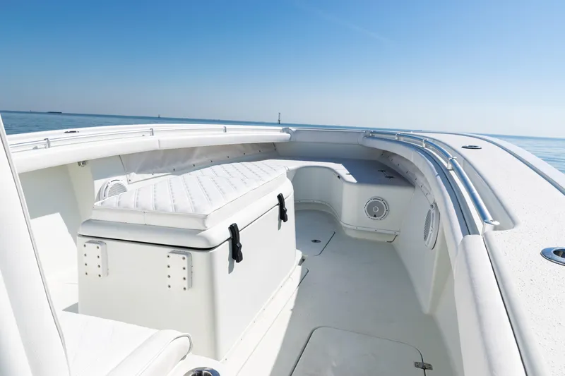Slide: The Image of 2014 Yellowfin 36 Offshore boat interior with cushioned seating and ocean view. - 18