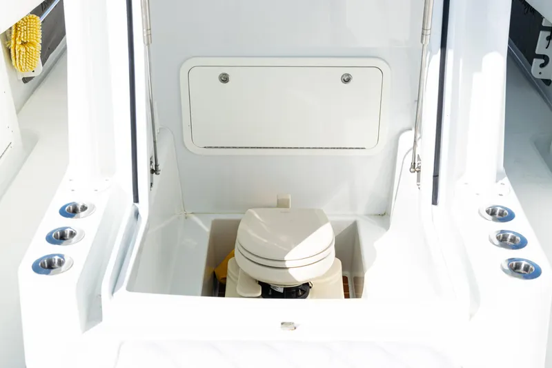 Slide: The Image of 2014 Yellowfin 36 Offshore boat interior with compact marine toilet. - 19