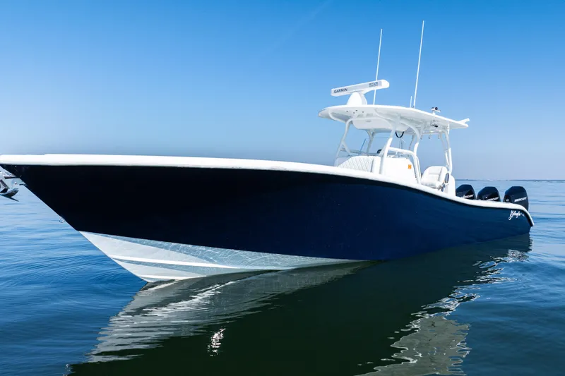 Slide: The Image of 2014 Yellowfin 36 Offshore boat on calm water under clear blue sky. - 2
