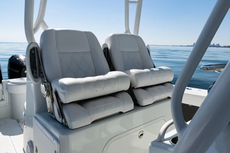 Slide: The Image of 2014 Yellowfin 36 Offshore boat with luxurious white seating on calm water. - 27