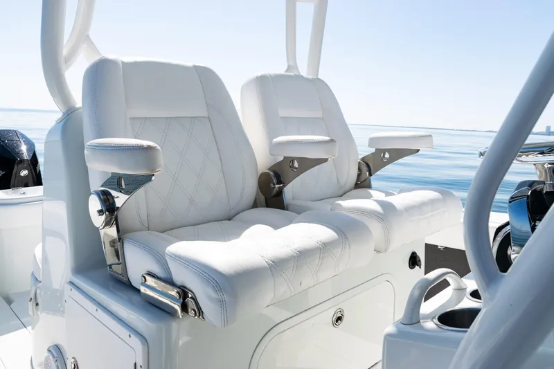 Slide: The Image of 2014 Yellowfin 36 Offshore boat with luxurious white seating and ocean backdrop. - 29