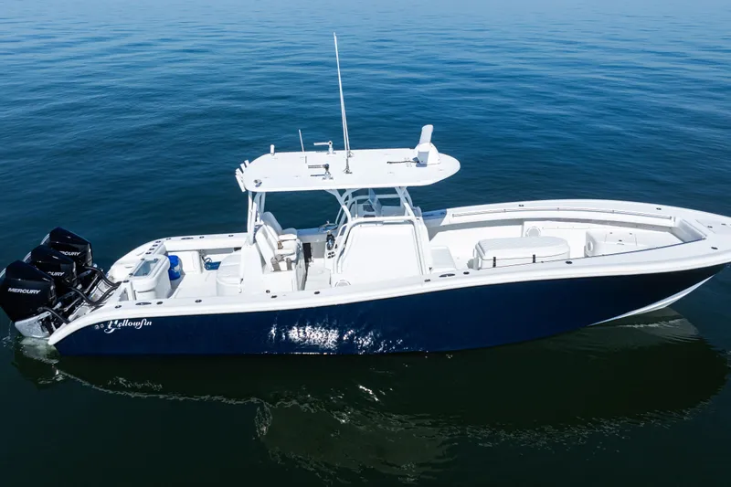 Slide: The Image of 2014 Yellowfin 36 Offshore boat on calm blue water, featuring triple Mercury engines. - 3