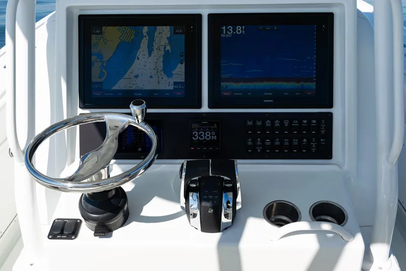 Slide: The Image of Control panel of 2014 Yellowfin 36 Offshore boat with navigation screens and steering wheel. - 33