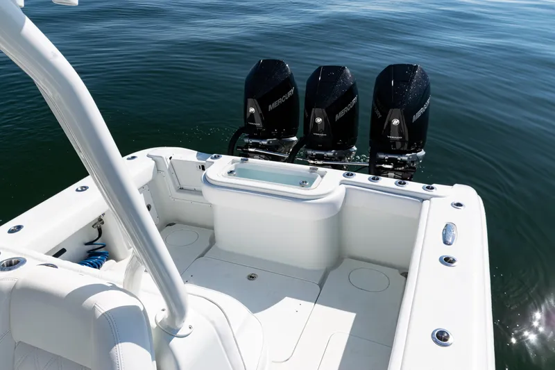 Slide: The Image of 2014 Yellowfin 36 Offshore boat with triple Mercury engines on calm water. - 36
