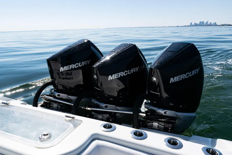 Slide: The Image of 2014 Yellowfin 36 Offshore boat with triple Mercury outboard engines on calm water. - 37
