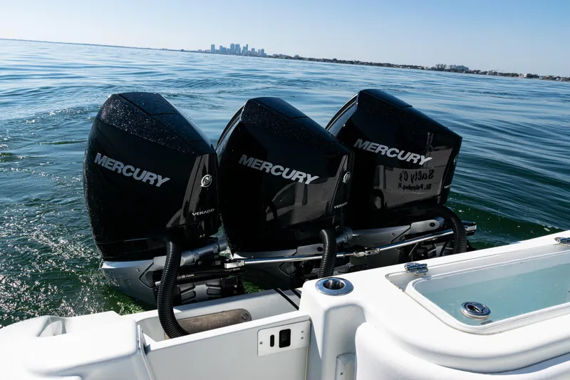 Slide: The Image of 2014 Yellowfin 36 Offshore with triple Mercury Verado engines on open water. - 38