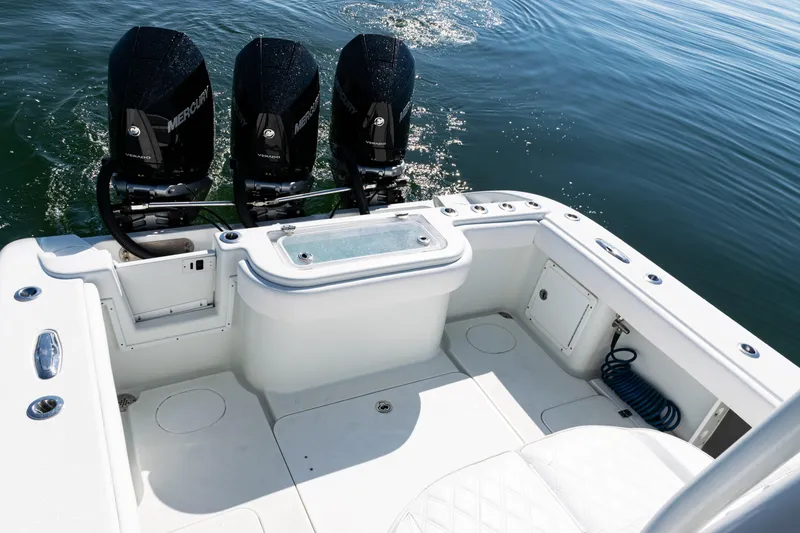 Slide: The Image of 2014 Yellowfin 36 Offshore boat with triple Mercury engines on calm water. - 39