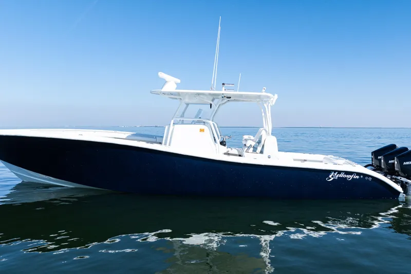 Slide: The Image of 2014 Yellowfin 36 Offshore boat on calm water under clear blue sky. - 4