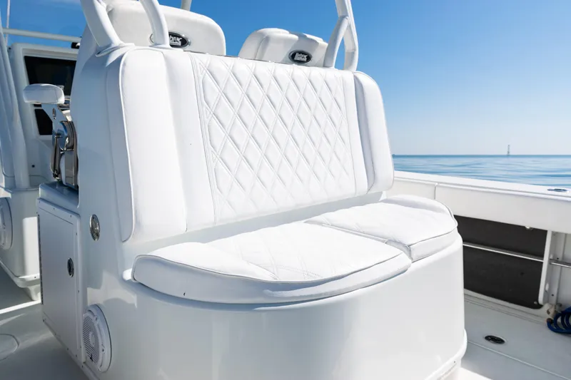Slide: The Image of 2014 Yellowfin 36 Offshore boat with white cushioned seating, ocean view. - 42