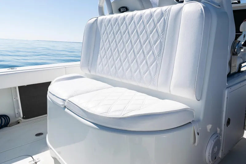 Slide: The Image of 2014 Yellowfin 36 Offshore boat with white cushioned seating, ocean view. - 43