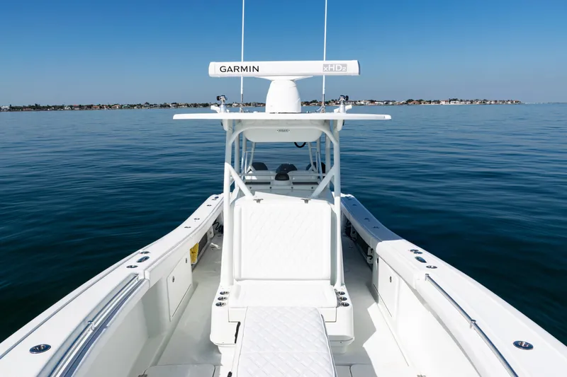 Slide: The Image of 2014 Yellowfin 36 Offshore boat on calm water, featuring Garmin equipment. - 44