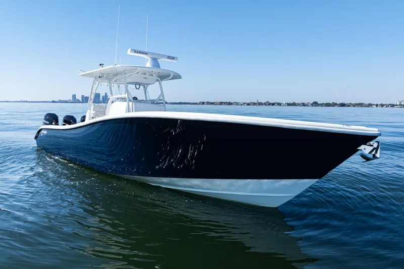 Slide: The Image of 2014 Yellowfin 36 Offshore boat cruising on calm water under clear blue sky. - 5