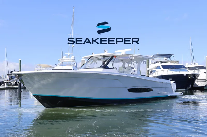 The Image of 2022 Regal 38 SAV boat docked, featuring Seakeeper stabilization technology. - 0