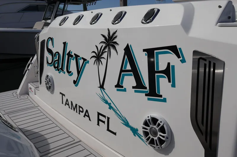 Slide: The Image of 2022 Regal 38 SAV boat with "Salty AF" and "Tampa FL" text on the side. - 24