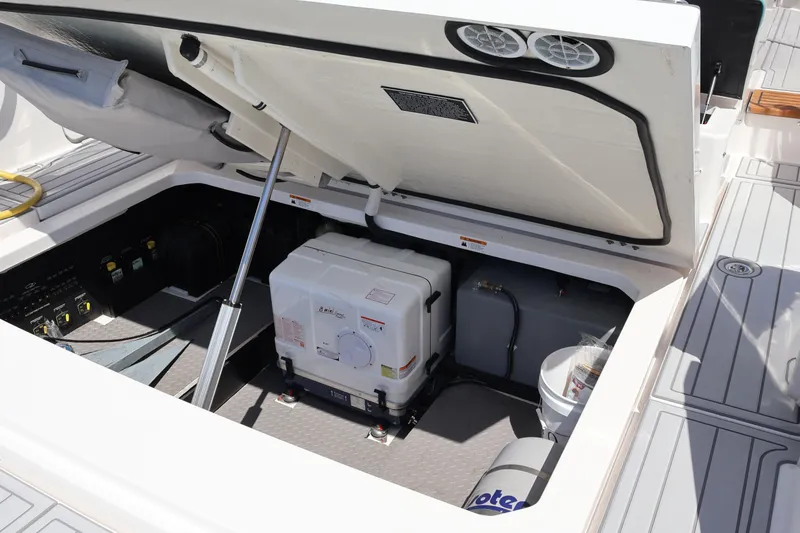 Slide: The Image of Open engine compartment of 2022 Regal 38 SAV boat, showcasing equipment and storage. - 26