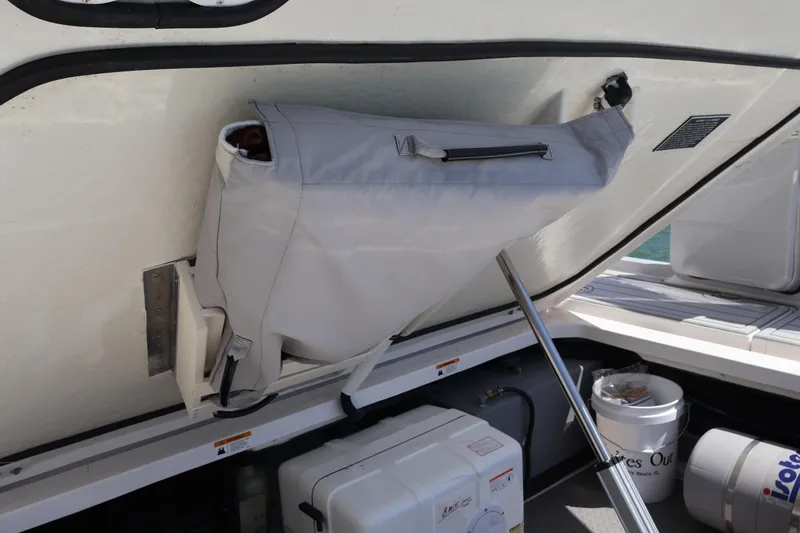 Slide: The Image of Storage compartment on a 2022 Regal 38 SAV boat, featuring a covered bag and equipment. - 30