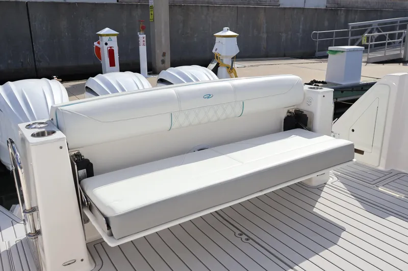 Slide: The Image of 2022 Regal 38 SAV boat with white seating and triple outboard engines. - 31