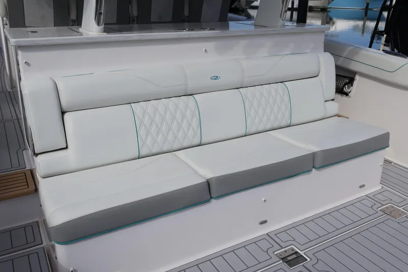 Slide: The Image of 2022 Regal 38 SAV boat interior with elegant white seating and diamond stitching. - 34