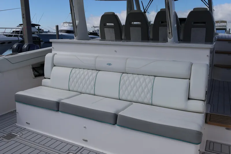Slide: The Image of 2022 Regal 38 SAV boat seating area with luxurious white and gray upholstery. - 35