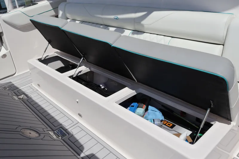Slide: The Image of 2022 Regal 38 SAV boat with open storage compartments on deck. - 38