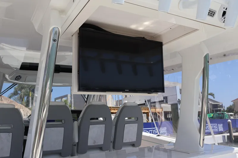 Slide: The Image of 2022 Regal 38 SAV boat interior with mounted TV and seating area. - 39