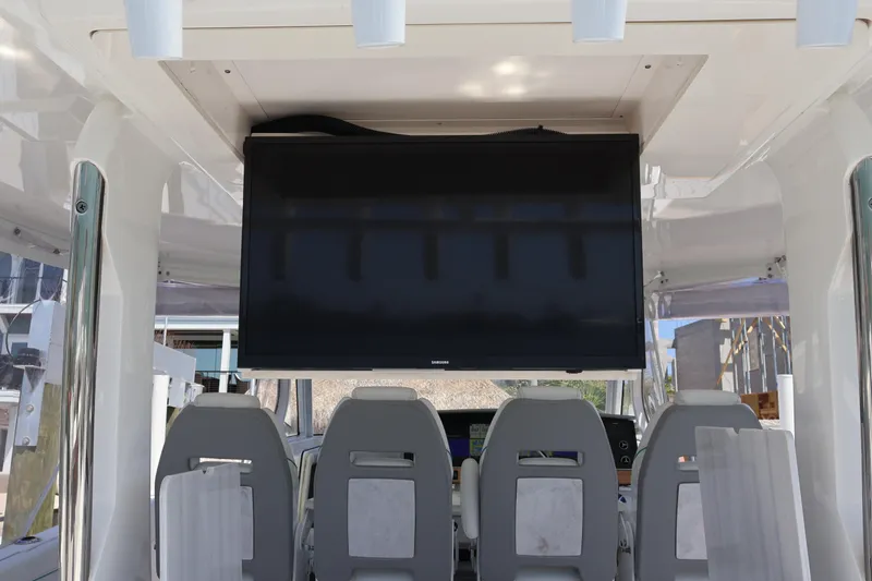Slide: The Image of 2022 Regal 38 SAV boat interior with mounted TV and seating area. - 41