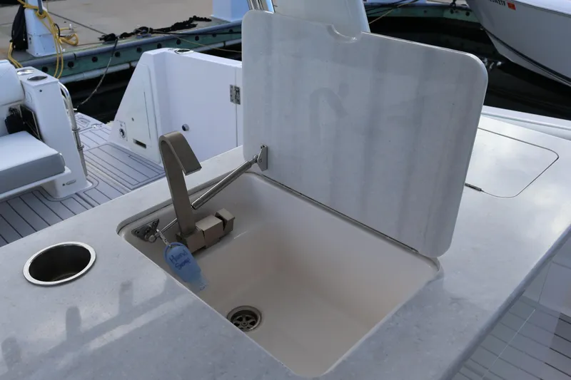 Slide: The Image of 2022 Regal 38 SAV boat sink with faucet and countertop detail. - 48