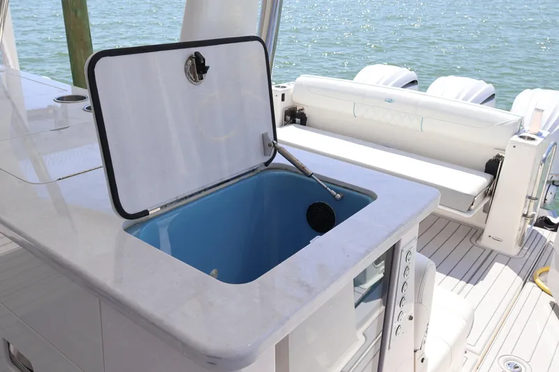 Slide: The Image of 2022 Regal 38 SAV boat with open storage compartment and seating area. - 50