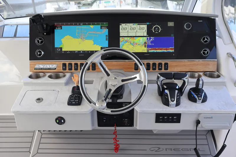 Slide: The Image of 2022 Regal 38 SAV boat dashboard with navigation screens and controls. - 62