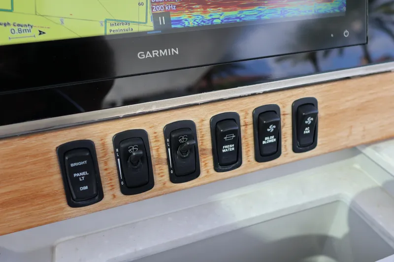 Slide: The Image of Control panel of 2022 Regal 38 SAV boat with Garmin display and switches. - 69