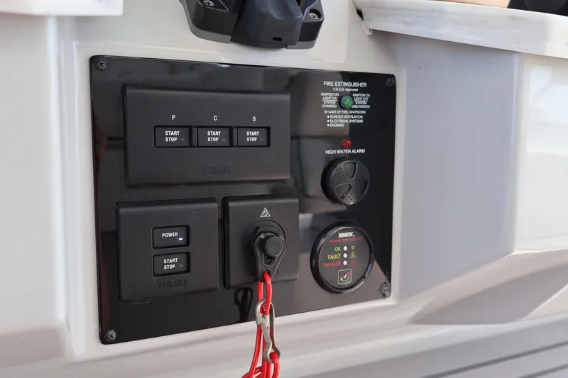 Slide: The Image of Control panel of 2022 Regal 38 SAV boat with start-stop buttons and safety indicators. - 70