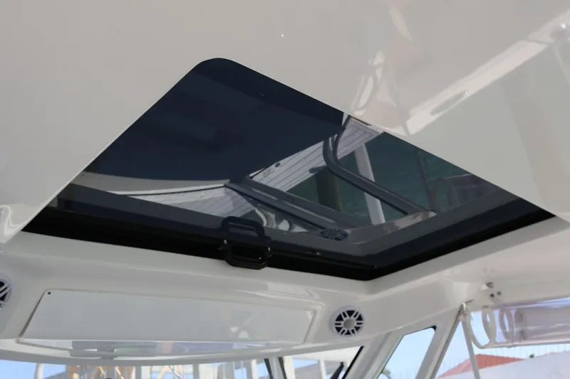 Slide: The Image of 2022 Regal 38 SAV boat interior with open sunroof and sleek design. - 71