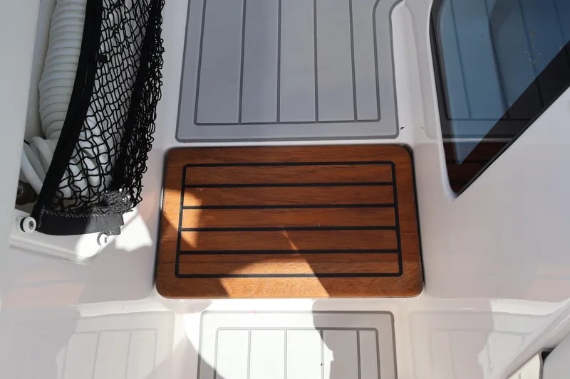 Slide: The Image of 2022 Regal 38 SAV boat deck with wooden panel and storage net. - 74