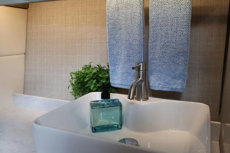 Slide: The Image of Modern bathroom sink with blue towels and soap, Regal 38 SAV 2022 model. - 84