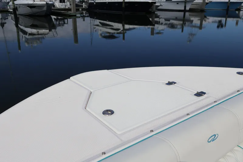 Slide: The Image of 2022 Regal 38 SAV boat deck at marina with reflections on water. - 87