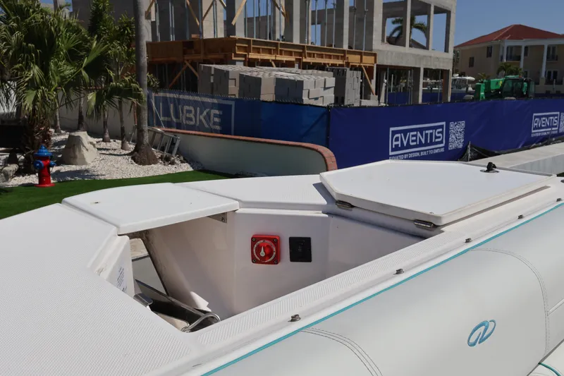 Slide: The Image of 2022 Regal 38 SAV boat docked near construction site with palm trees. - 88