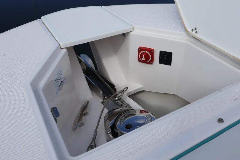 Slide: The Image of 2022 Regal 38 SAV boat anchor compartment with control panel and storage. - 90
