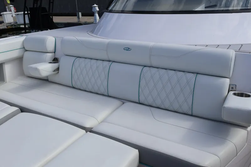 Slide: The Image of 2022 Regal 38 SAV boat with luxurious white seating and cup holders. - 94