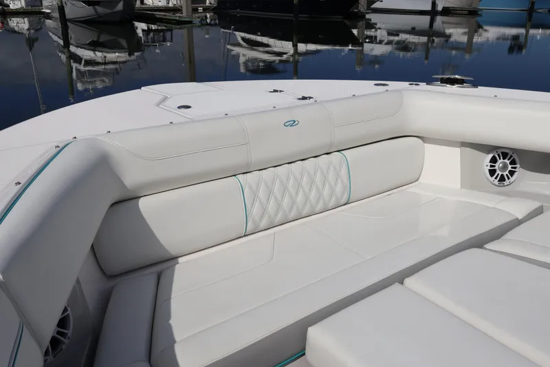 Slide: The Image of 2022 Regal 38 SAV boat interior with white cushioned seating and speaker. - 95